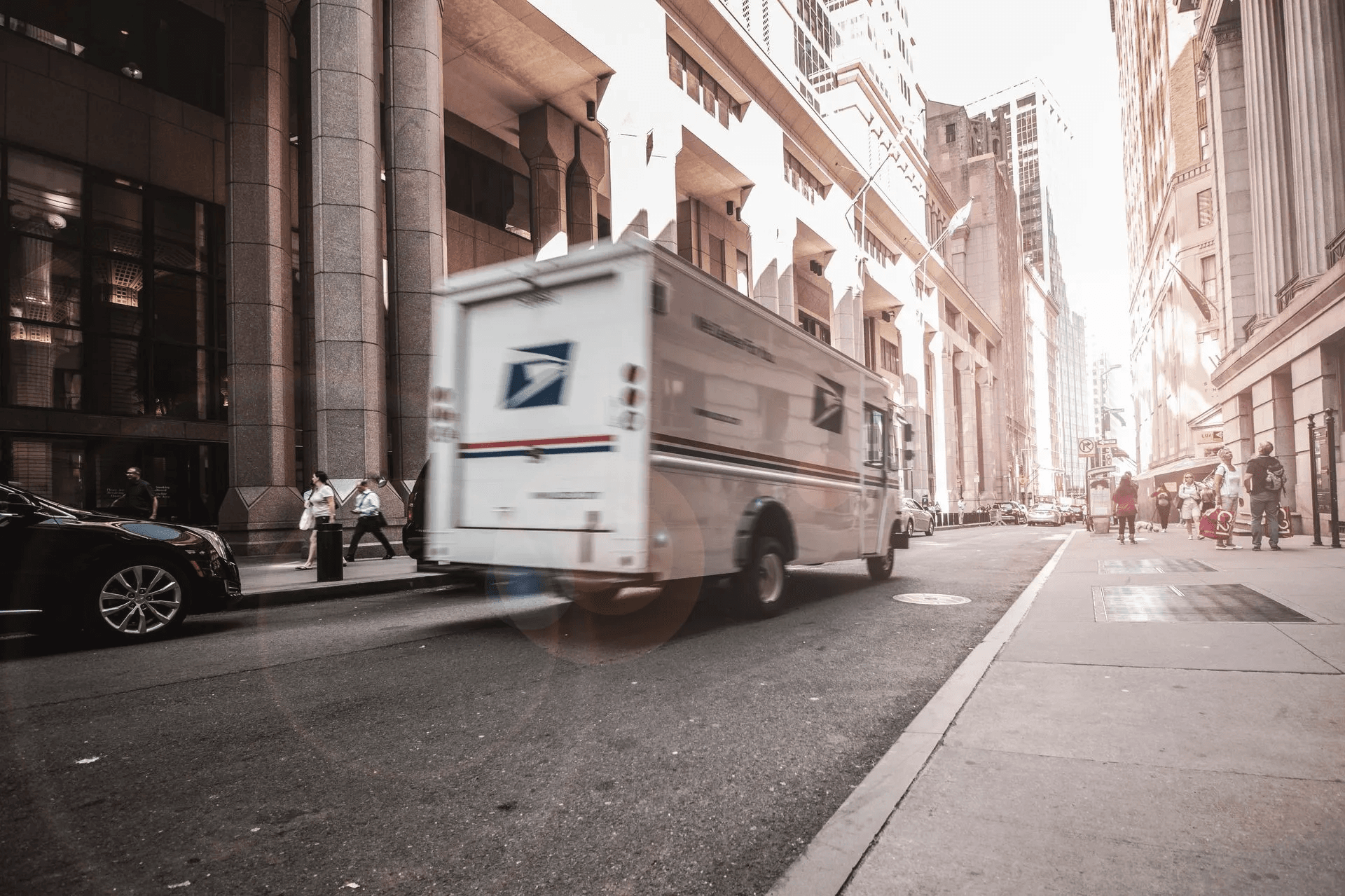 Delivery van driving through a busy city street